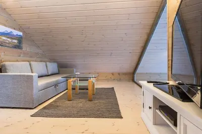 a living room with a couch and a table at Stranda Fjellgrend 2 bedrooms and loft - 24B in Stranda