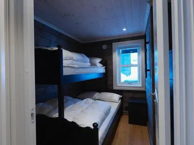 a bedroom with two bunk beds and a window at Stranda Fjellgrend 3 bedrooms - 32A in Stranda