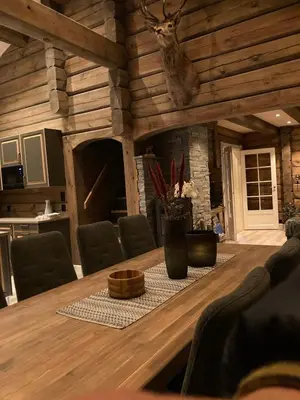 a dining room with a table with a deer head on the wall at Luster Lodge in Luster