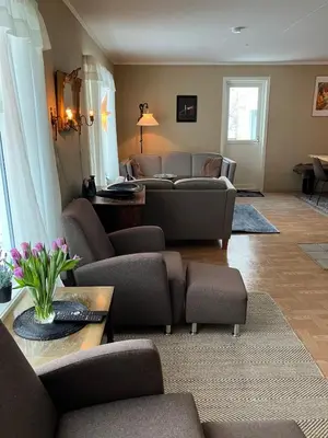 a living room with two couches and a table at Holiday home in Espevær in Bømlo