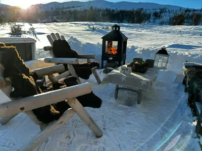 a snow covered yard with a fireplace in the snow at Mountain Cabin With Magical Views At Dagalifjell in Uvdal