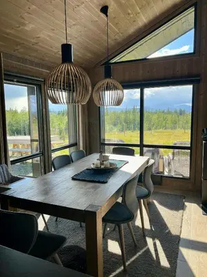 a dining room with a wooden table and chairs at Opplev Den Unike Stemningen På Golsfjellet in Gol