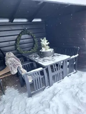 a table with a cake and a wreath on it at Bjorlicabin in Bjorli