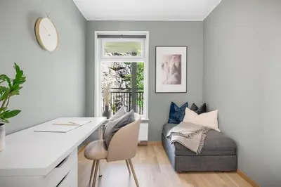 a living room with a desk and a couch at Modern apartment by the sea - Free parking in Bergen