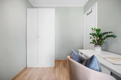 a room with a desk with a potted plant at Modern apartment by the sea - Free parking in Bergen