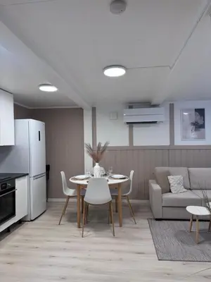 a living room with a table and a couch at Kirkevegen apartment in Brumunddalen