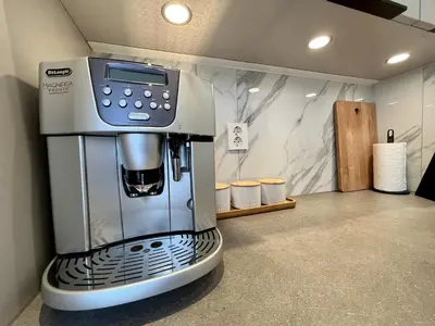 a kitchen with a coffee machine in a room at Exclusive apartment in historical house, Bergen in Bergen