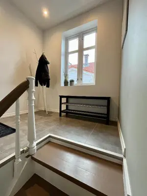 a stairway with a bench and a window at Exclusive top apartment, central location in Bergen in Bergen