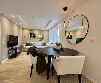 a dining room with a table and a mirror at Beautiful apartment in Bergen in Bergen