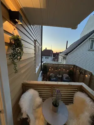 two dogs sitting on a balcony with a table at Beautiful apartment in Bergen in Bergen