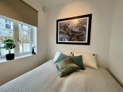 a bedroom with a bed with a picture on the wall at Beautiful apartment in Bergen in Bergen