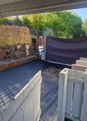 an outdoor deck with a bench and a fence at Modern condominium in Bergen