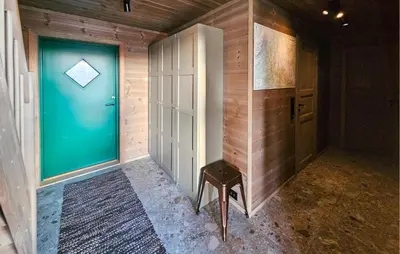 a hallway with a blue door and a stool at Lovely Home In Eggedal With Wifi in Eggedal