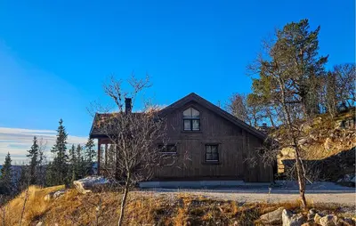 a wooden house sitting on top of a hill at Lovely Home In Eggedal With Wifi in Eggedal