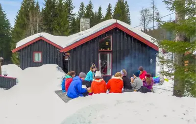 a group of children in front of a building in the snow at 4 Bedroom Nice Home In Trysil in Trysil