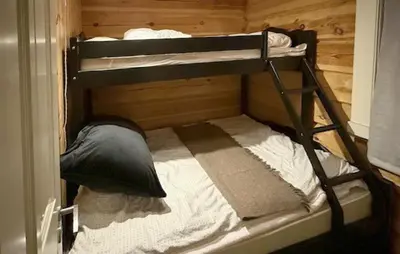 a bunk bed in a wooden room with a bunk bed in a cabin at 4 Bedroom Pet Friendly Home In Svingvoll in Svingvoll
