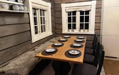 a wooden table in a room with chairs and a table sidx sidx sidx at 4 Bedroom Pet Friendly Home In Svingvoll in Svingvoll