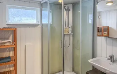 a bathroom with a glass shower and a sink at Cozy Home In Oppdal With House A Mountain View in Oppdal