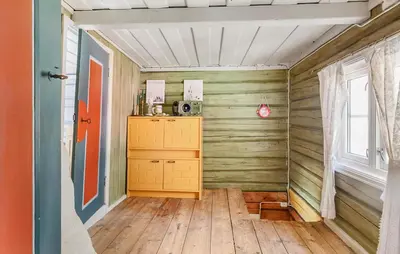 a room with a wooden floor and a wooden cabinet at 2 Bedroom Stunning Home In Bjugn in Moen