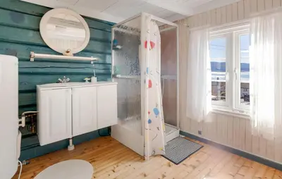 a bathroom with a shower and a sink and a mirror at 2 Bedroom Stunning Home In Bjugn in Moen