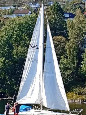a sail boat on the water with people on it at Bakarvågen 2