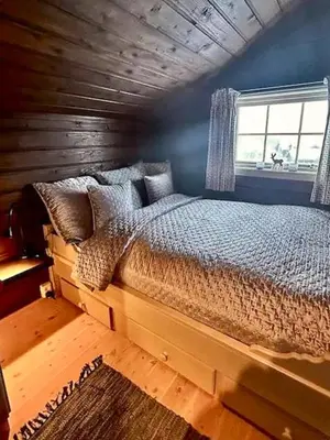 a bedroom with a bed in a room with a window at Lovely Family Cabin Near Ski Stadium In Beitostølen in Beitostøl