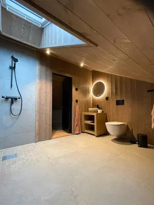 a bathroom with a tub and a toilet and a sink at Lovely Cabin With Hot Tub Near Syningtoppen in Torpo