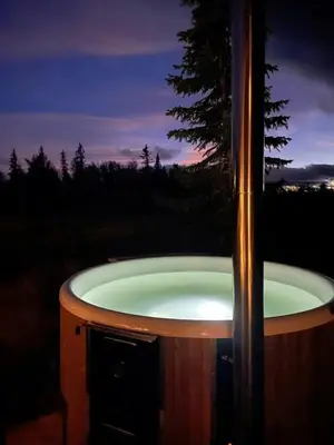 a jacuzzi tub in a field at night at Lovely Cabin With Hot Tub Near Syningtoppen in Torpo