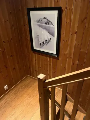 a picture hanging on a wall in a room with a bench at Charming and modern ski-in ski-out cottage in Hemsedal