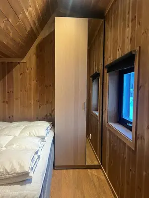 a bedroom with a bed and a window at Charming and modern ski-in ski-out cottage in Hemsedal