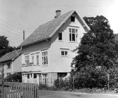 a black and white photo of a house at Lundenhuset 1917 - historic house in the heart of Ulsteinvik in Ulstein