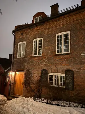 a brick building with snow in front of it at Central, charming, 1800s apartment in Lii