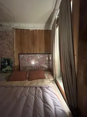 a large bed in a room with a window at Central, charming, 1800s apartment in Lii
