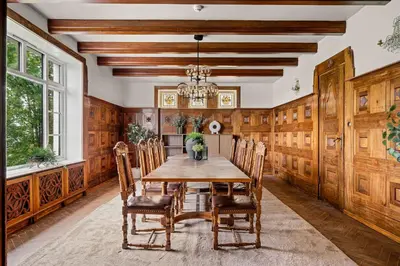 a dining room with a wooden table and chairs at Elegant Historic Villa - Stunning Views in Bergen