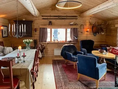 a living room with a table and chairs in a room at Enjoy Days In Traditional Log Cabin in Uvdal