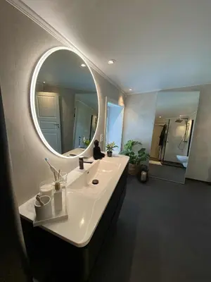 a bathroom with a sink and a large mirror at Penthouse apartment 2 bedrooms 70 m2 in Verdal