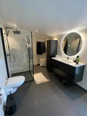 a bathroom with a toilet and a sink and a shower at Penthouse apartment 2 bedrooms 70 m2 in Verdal