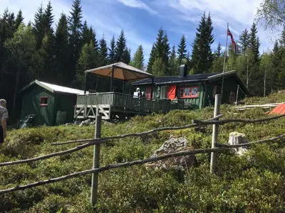 a house on a hill with people standing on the deck at Øyungen 2 in Namsos