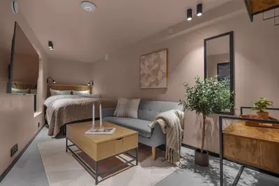 a living room with a couch and a bed at Tromsø Apartment - in the heart of the city in Lii