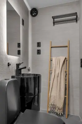 a bathroom with a sink and a towel at Tromsø Apartment - in the heart of the city in Lii