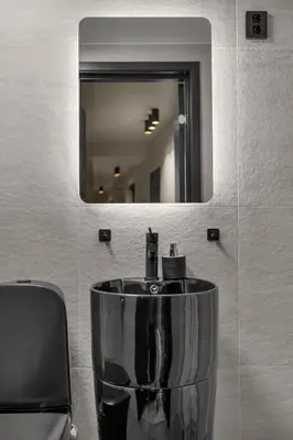 a sink in a bathroom with a mirror at Tromsø Apartment - in the heart of the city in Lii