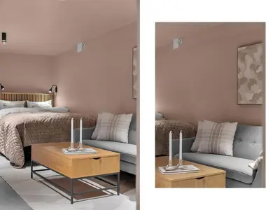 a living room with a bed and a table with candles on it at Tromsø Apartment - in the heart of the city in Lii