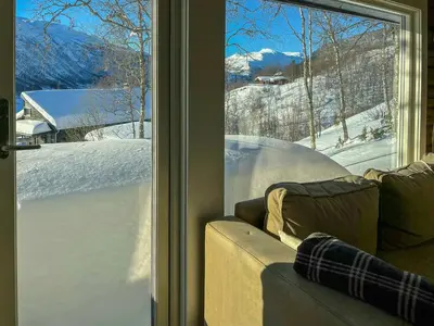 a living room with a view of a snow covered yard at Timber Cabin With Ski-In Access At Solheisen in Hemsedal