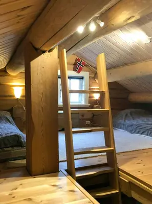 a loft bed in a room with two beds at Log Cabin Near Muen And Myafallene in Venabygd