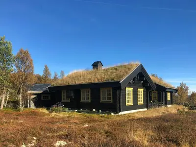 a house with a grass roof on top of it at Log Cabin Near Muen And Myafallene in Venabygd