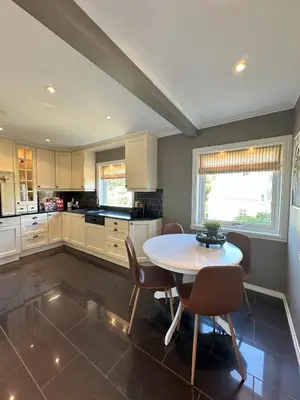 a kitchen with a table and chairs in a room at Spacious Group Villa with Jacuzzi and Views in Askøy