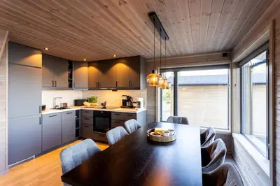 a kitchen and dining room with a table and chairs at Viking Lodge Panorama-Norefjell in Noresund