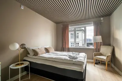 a bedroom with a bed with a striped ceiling at Central Bergen - Stylish & Cozy in Bergen