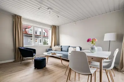 a living room with a couch and a table and chairs at Central Bergen - Stylish & Cozy in Bergen