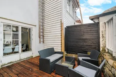 a patio with two chairs and a table at Central Bergen - Stylish & Cozy in Bergen